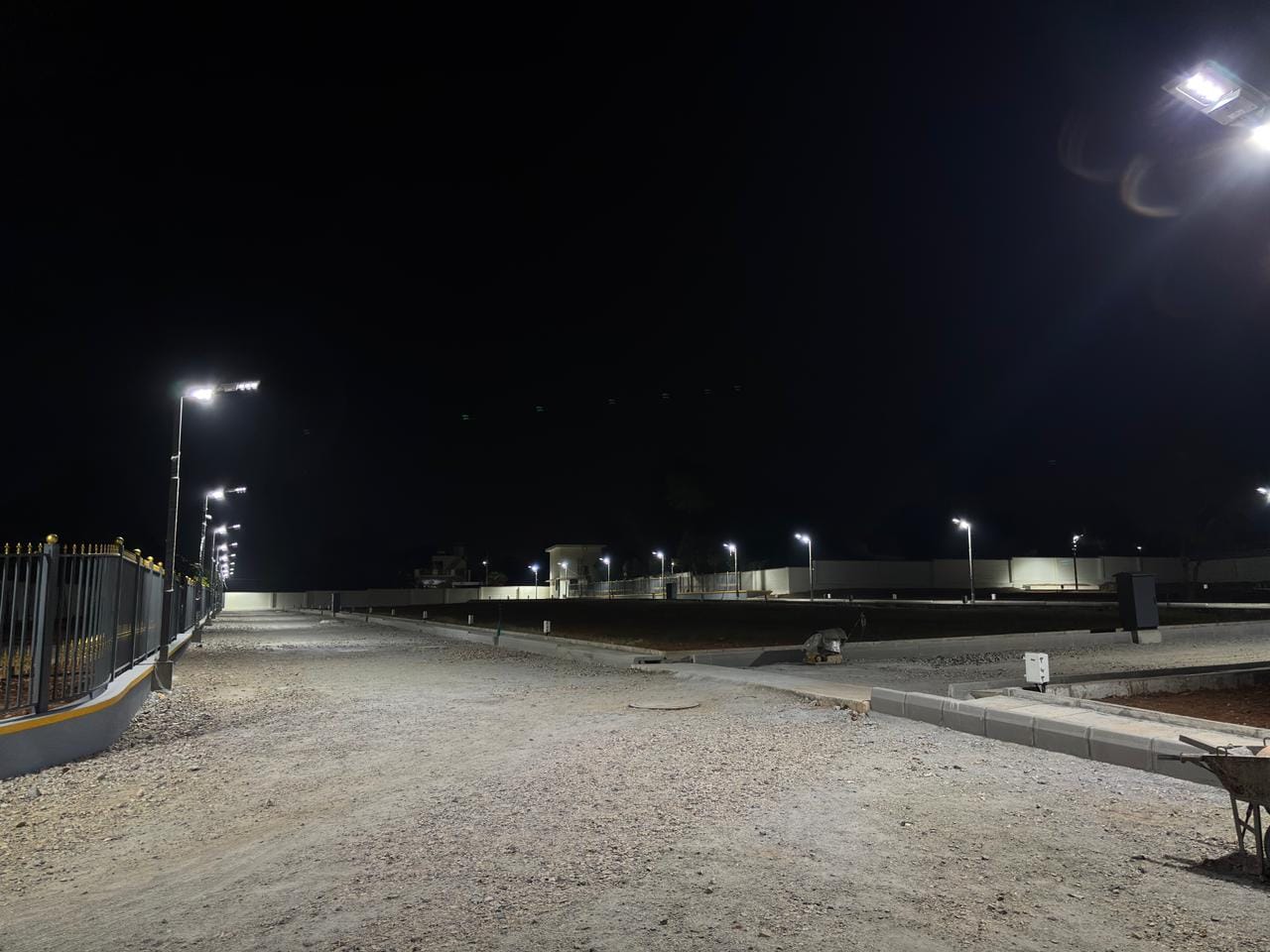 Solar street lights on a layout road at Kanakapura, lit at night